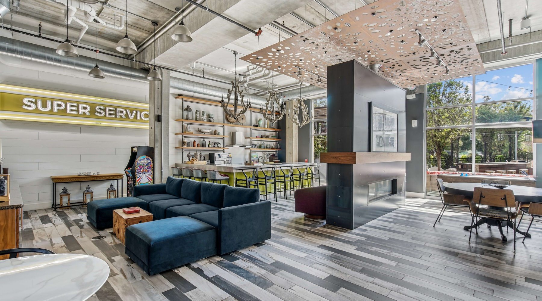 Resident lounge at Albion at Morrow Park Apartments in Pittsburgh, PA, featuring ample seating and wood grain flooring.