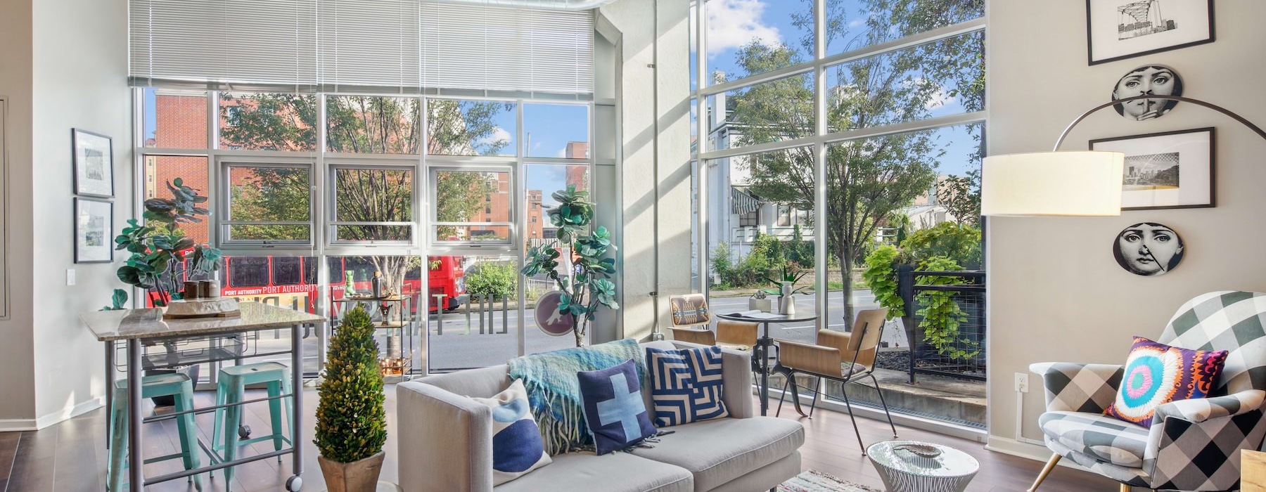 Resident lounge at Albion at Morrow Park Apartments in Pittsburgh, PA, featuring ample seating and floor to ceiling windows.